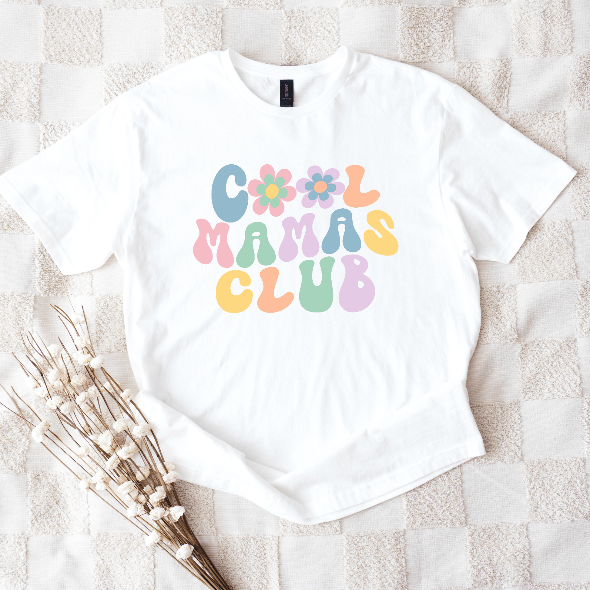 White tee with pastel retro bubble letters and flowers reading Cool Mamas Club Shirt by Maddy and George Designs