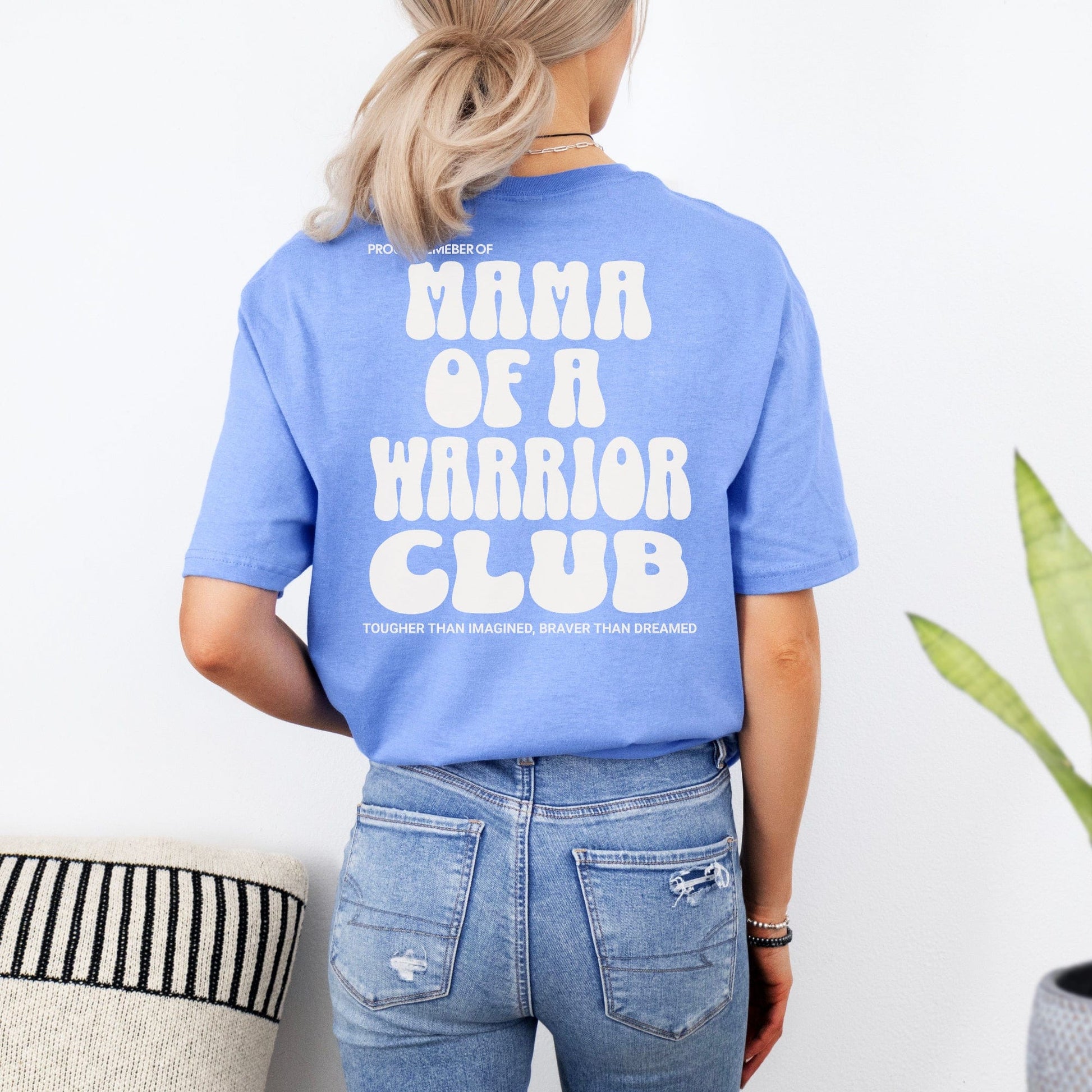 Back view of woman wearing blue tee with white retro print Mama of a Warrior Club Shirt by Maddy and George Designs
