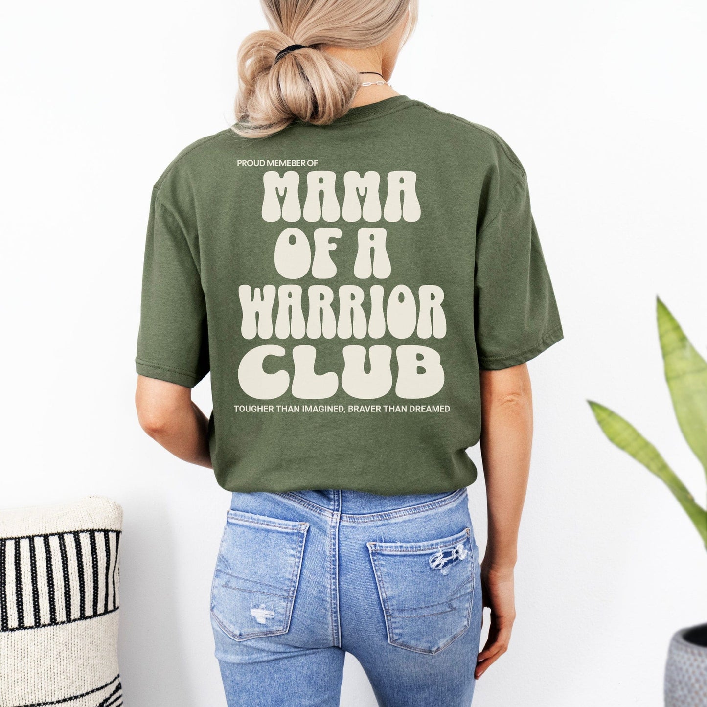 Back view of model wearing olive green Mama of a Warrior Club Shirt by Maddy and George Designs