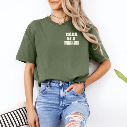Olive green Mama of a Warrior Club Shirt by Maddy and George Designs worn by woman styled with ripped jeans