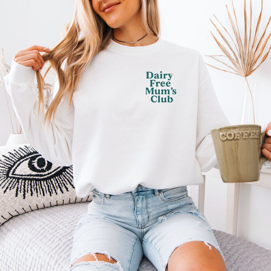Dairy Free Mum’s Club Sweatshirt . Woman wearing white sweatshirt with teal chest logo holding coffee mug
