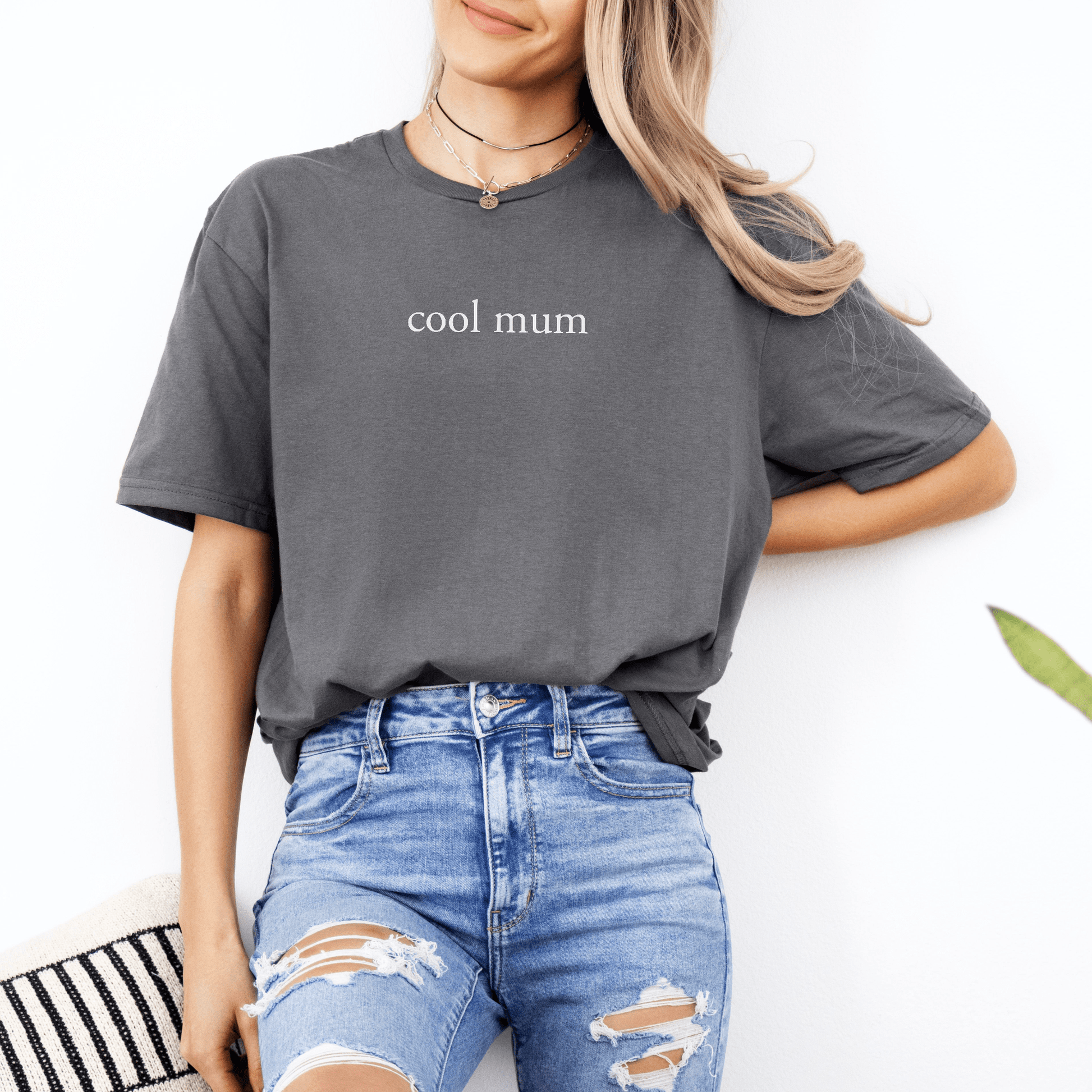 Maddy and George Designs Cool Mum Shirt charcoal tee with minimalist white print on smiling model wearing ripped jeans