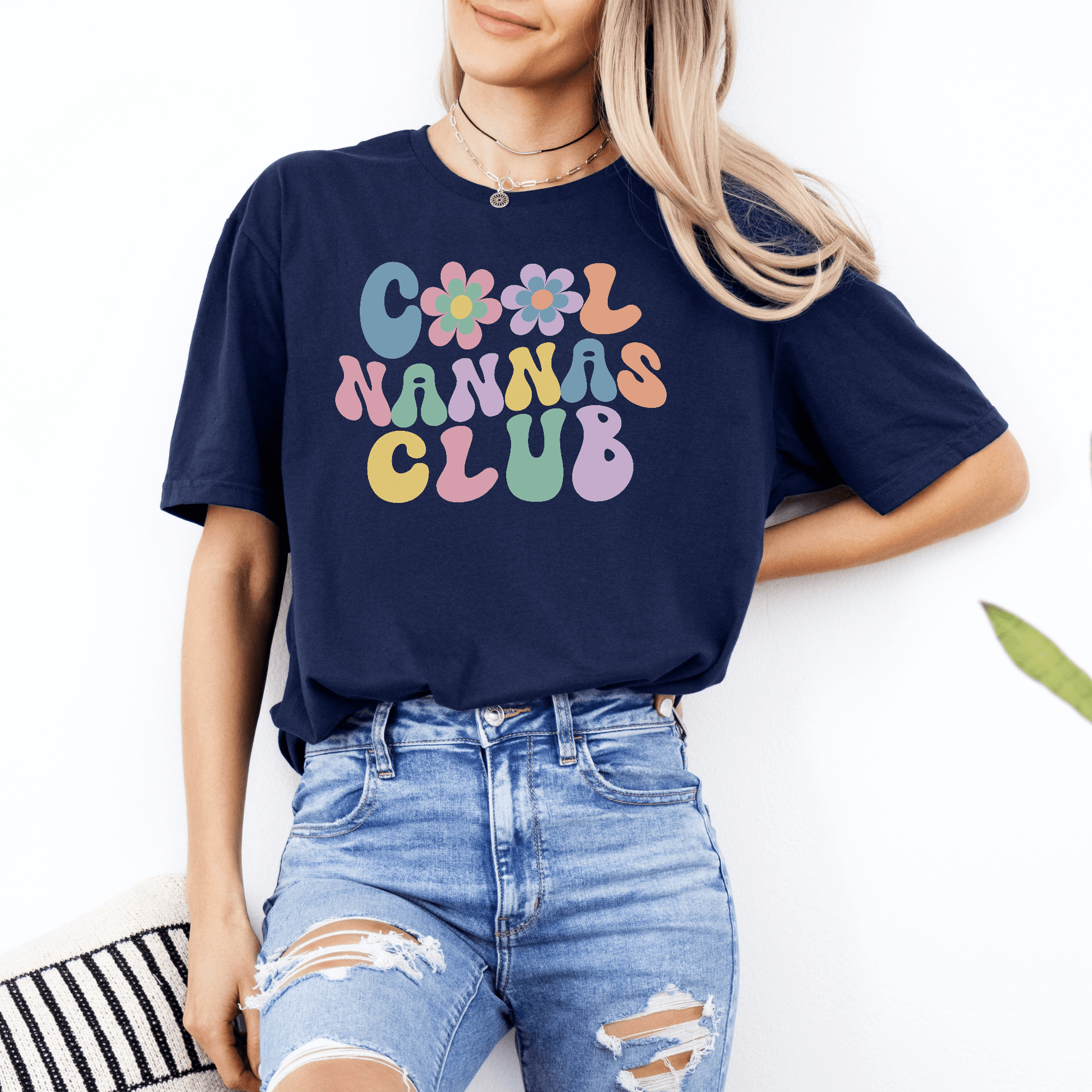 Cool Nannas Club Shirt navy tee with retro pastel bubble letters and flower graphics worn with ripped jeans