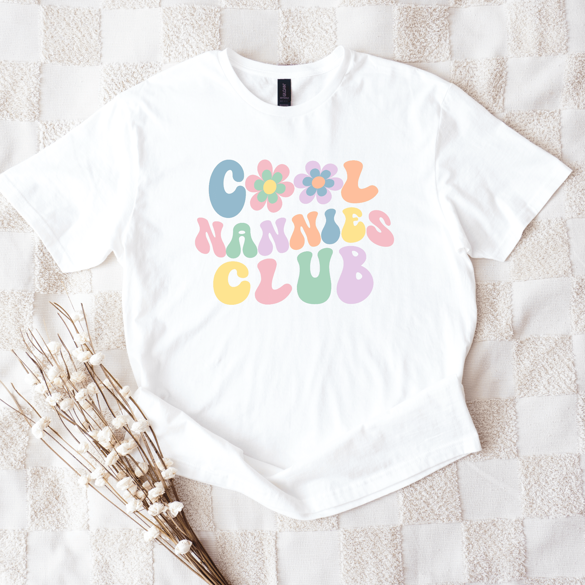 Cool Nannies Club Shirt white tee with pastel retro bubble letters and floral icons nanny gift
