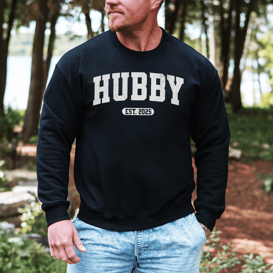 Custom Hubby EST Year Sweatshirt on man outdoors black crewneck with bold HUBBY print