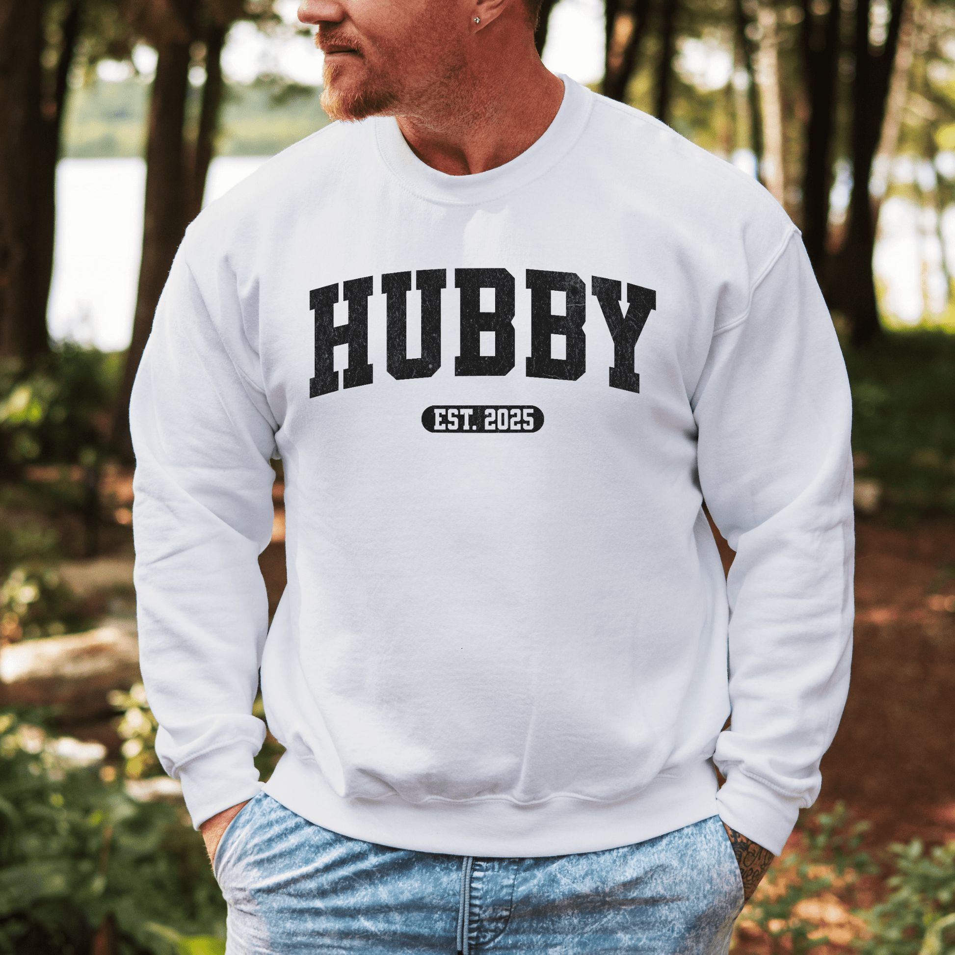 Man wearing white Custom Hubby EST Year Sweatshirt by Maddy and George Designs with bold black print perfect for new husband gifts
