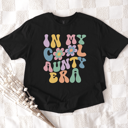 Black graphic tee with retro floral lettering reading In My Cool Aunty Era Shirt by Maddy and George Designs