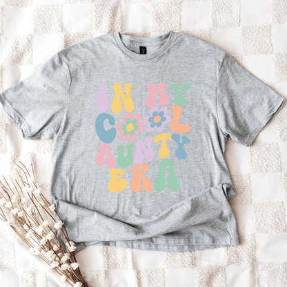 In My Cool Aunty Era Shirt gray tee with pastel retro bubble letters and flower graphic by Maddy and George Designs