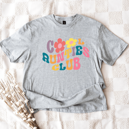 Gray unisex tee laid flat with colorful 70s floral lettering reading Retro Cool Aunties Club Shirt by Maddy and George Designs