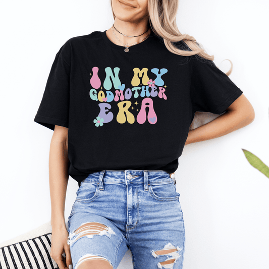 Black graphic tee with pastel retro bubble text In My Godmother Era print Godmother Announcement Shirt ideal for gifting