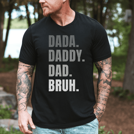 Maddy and George Designs print of man wearing black Dada. Daddy. Dad. Bruh Shirt. with bold stacked white text
