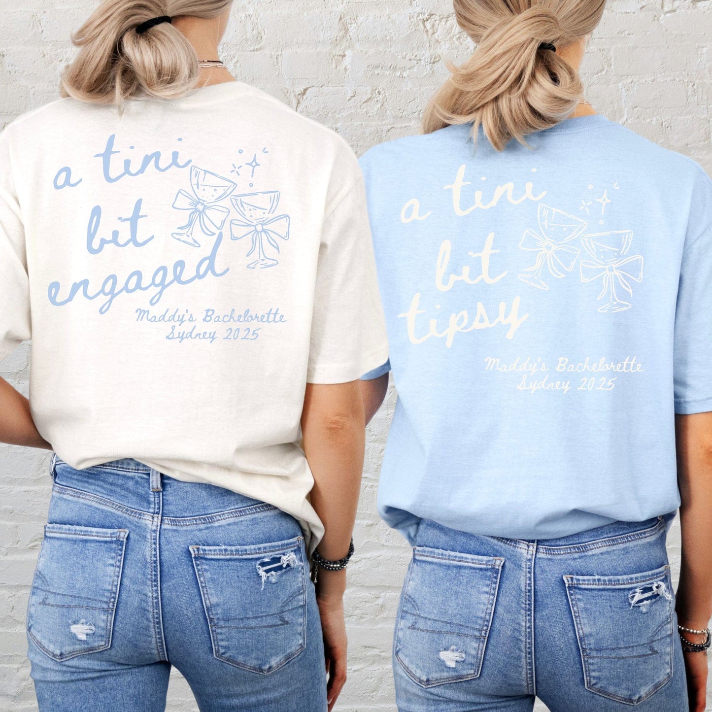 Back view of two women wearing Martini Bachelorette Shirts in cream and light blue with martini glass graphics
