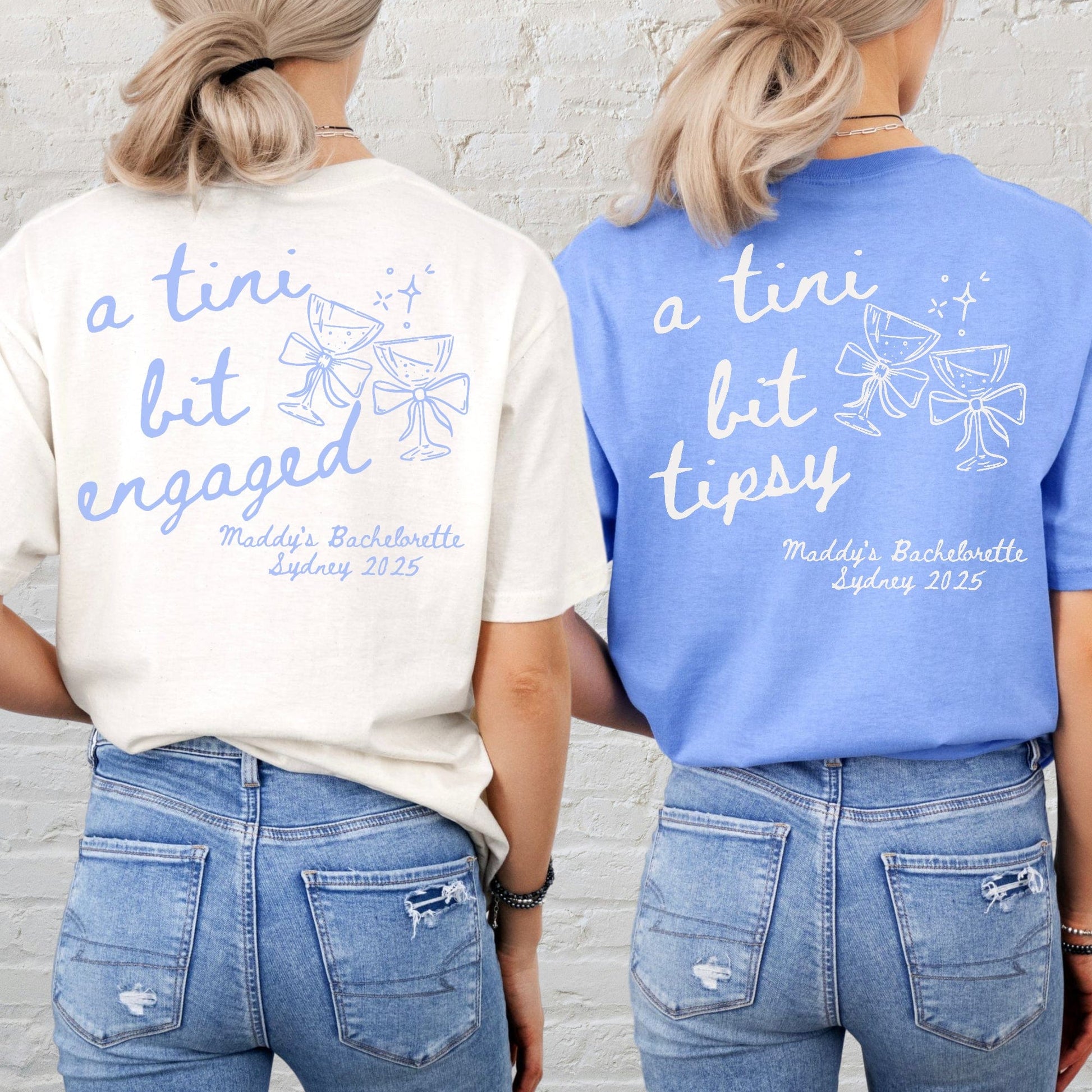 Two women wearing Martini Bachelorette Shirts Maddy and George Designs cream and blue tees with martini glass graphics on back