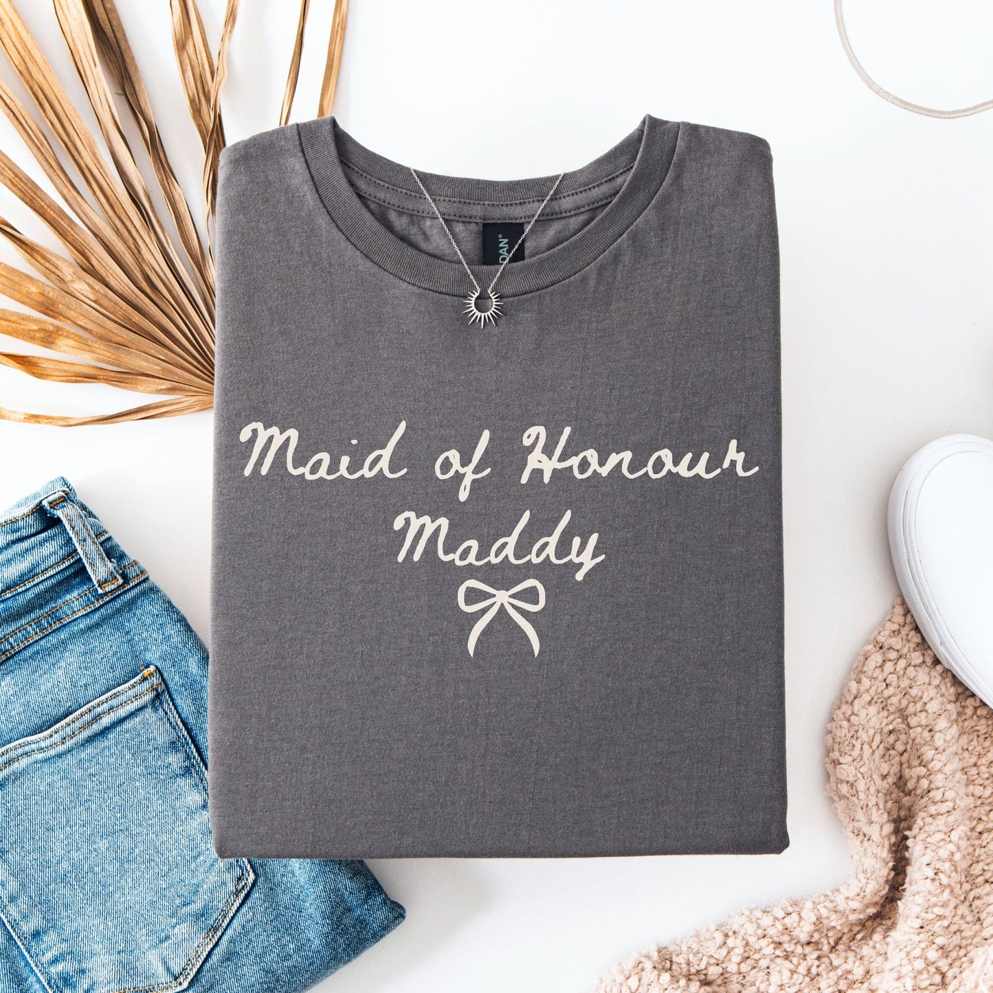 Custom Maid of Honour Shirt gray folded tee with cream script Maddy and bow styled with jeans necklace and sneakers