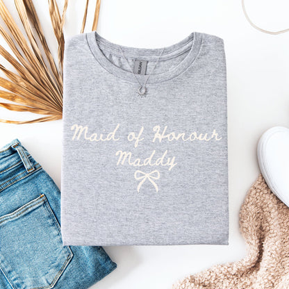 Custom Maid of Honour Shirt gray folded tee with cream script Maid of Honour Maddy styled with jeans and sneakers